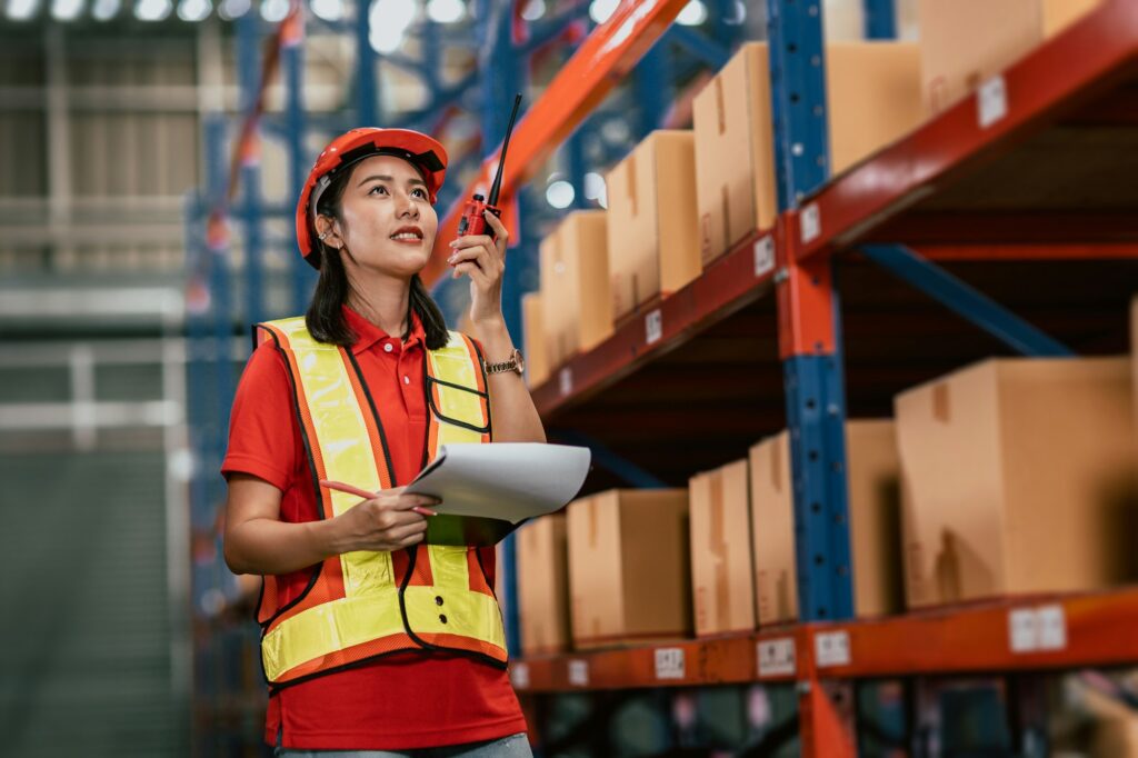 Warehouse woman staff worker cargo inventory products box store house with Asian worker